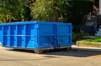 roll-off dumpster in front of a buildling