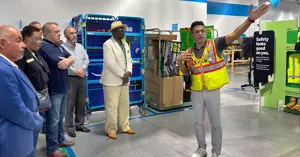 Amazon staff member leading a tour inside the Amazon facility for Bryan leadership