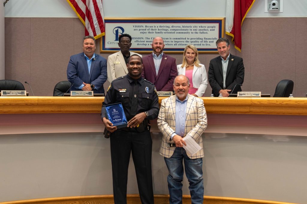 Photo of Bryan City Council with Bryan Police Officer Najee Watson