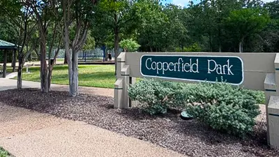 Copperfield Park sign with park in the background