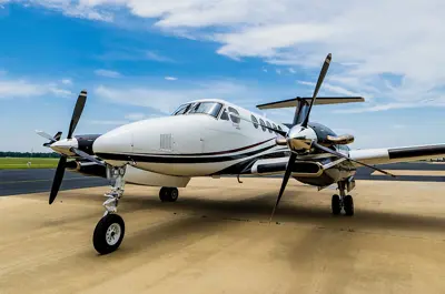 small airplane parked on the strip