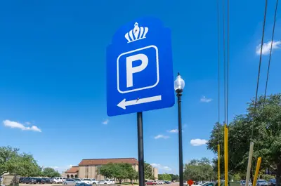 blue parking sign with downtown Bryan in the background