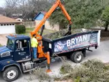 garbage truck picking up brush collection with mechanical arm