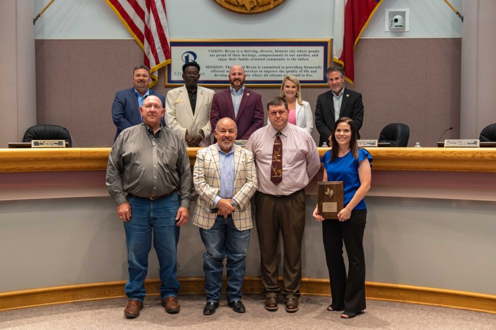 Photo of Bryan City Council with city staff and a representative from the Brazos Valley Groundwater Conservation District.