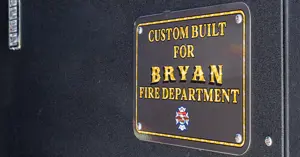 placard installed on the vehicle which reads "Custom Built for Bryan Fire Department"