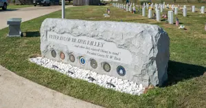 Veterans of Brazos Valley Memorial granite monument with cemetery behind