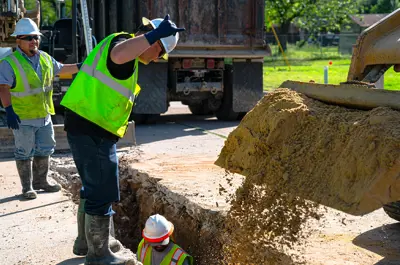 city employees repairing a main water pipe.