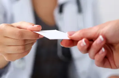 medical provider being handed an insurance card