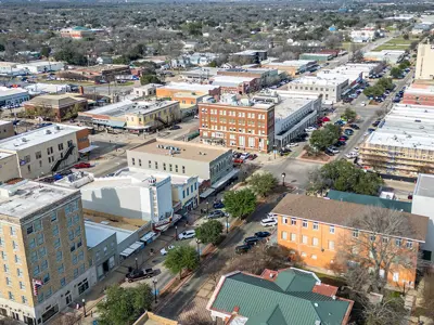 Aerial view of Historic Downtown Bryan on a sunny day, with the Queen Theatre area in the foreground.