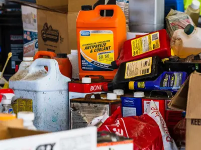 collection of bottled hazardous waste products and chemicals piled up.