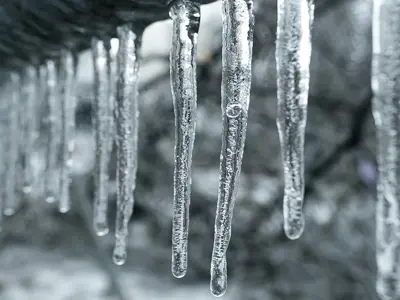 icicles frozen from a roofline during extreme freeze