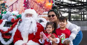 Family with children posing for a photo with Santa Claus.