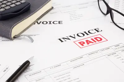 printed invoice with a "Paid" stamp