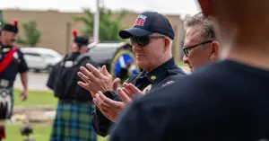 Fire Chief Richard Giusti applauding in celebration during the new fire truck ceremony