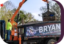 City of Bryan Solid Waste employee operating a truck crane arm