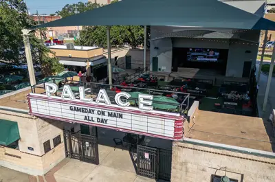 Aerial view of the Palace Theater. The marquee says Gameday On Main - All Day.