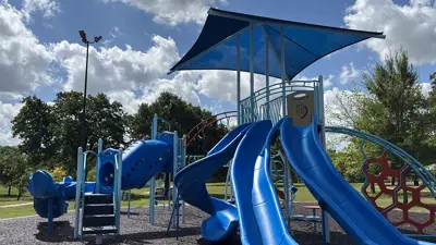 Three blue slides at the new Claude Scurry Park playground.