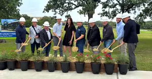 City of Bryan leadership and sponsors smiling and holding up shovels of dirt for the ceremonial groundbreaking of the Midtown Park Legacy Playground