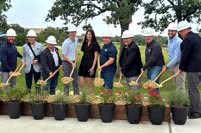City of Bryan leadership and sponsors smiling and holding up shovels of dirt for the ceremonial groundbreaking of the Midtown Park Legacy Playground