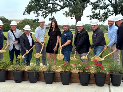 City of Bryan leadership and sponsors smiling and holding up shovels of dirt for the ceremonial groundbreaking of the Midtown Park Legacy Playground