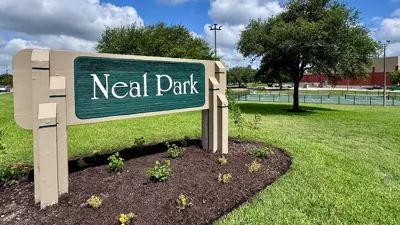 Neal Park sign with park in the background