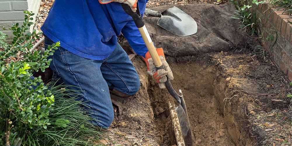 man replacing a sewer line