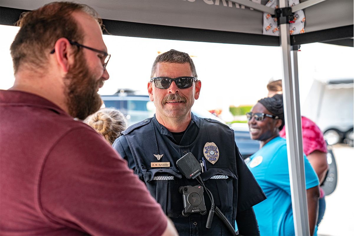 Police officer talking to a person and smling