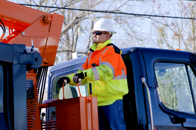 Photo of a Solid Waste worker operating a grapple truck.