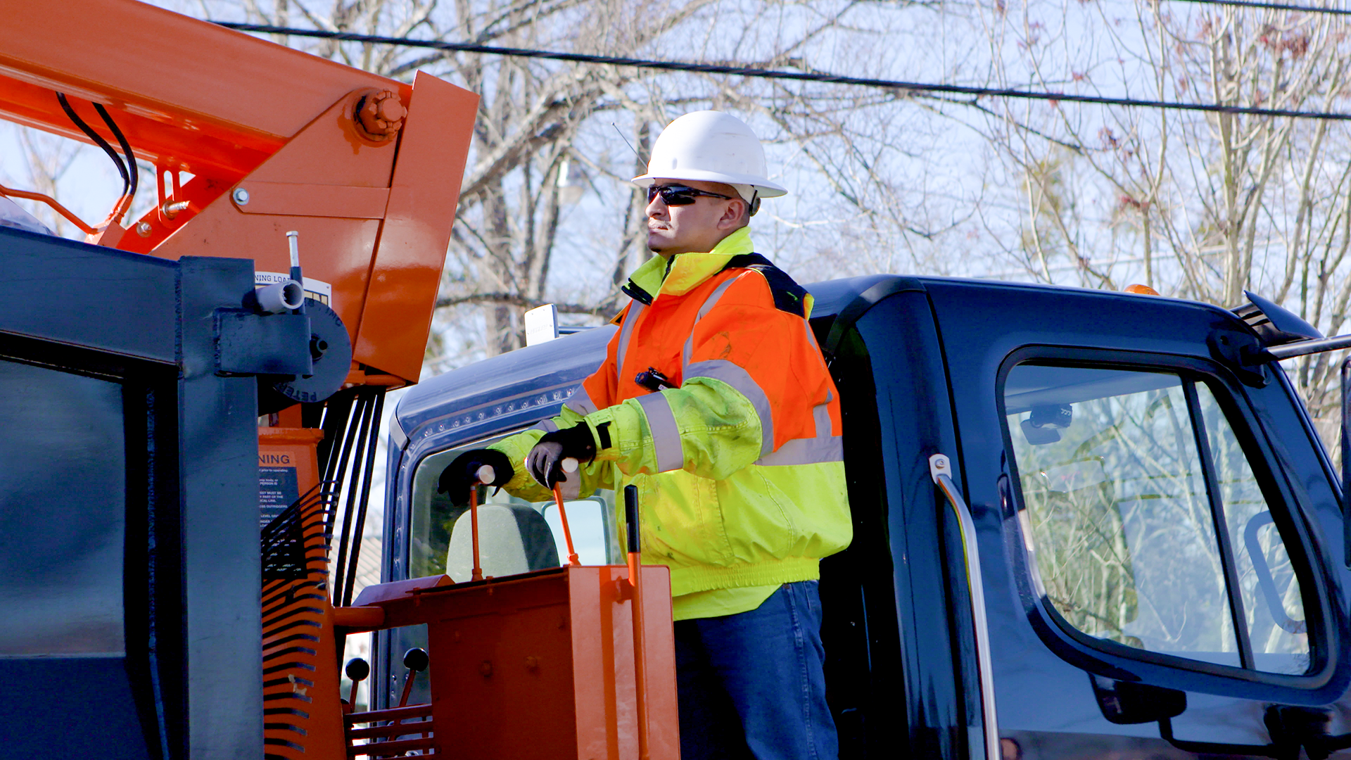 Photo of a Solid Waste worker operating a grapple truck.