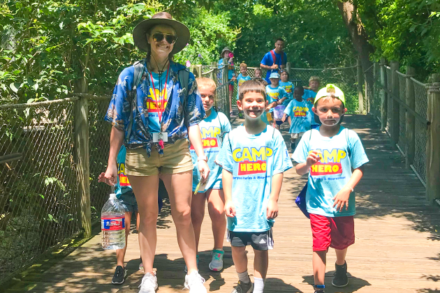 Camp Counselor with kids on a field trip at the zoo.