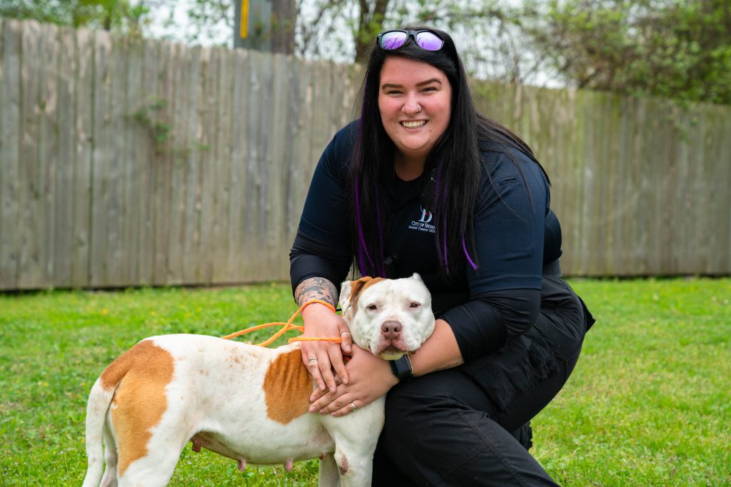 Animal Control officer smiling with dog