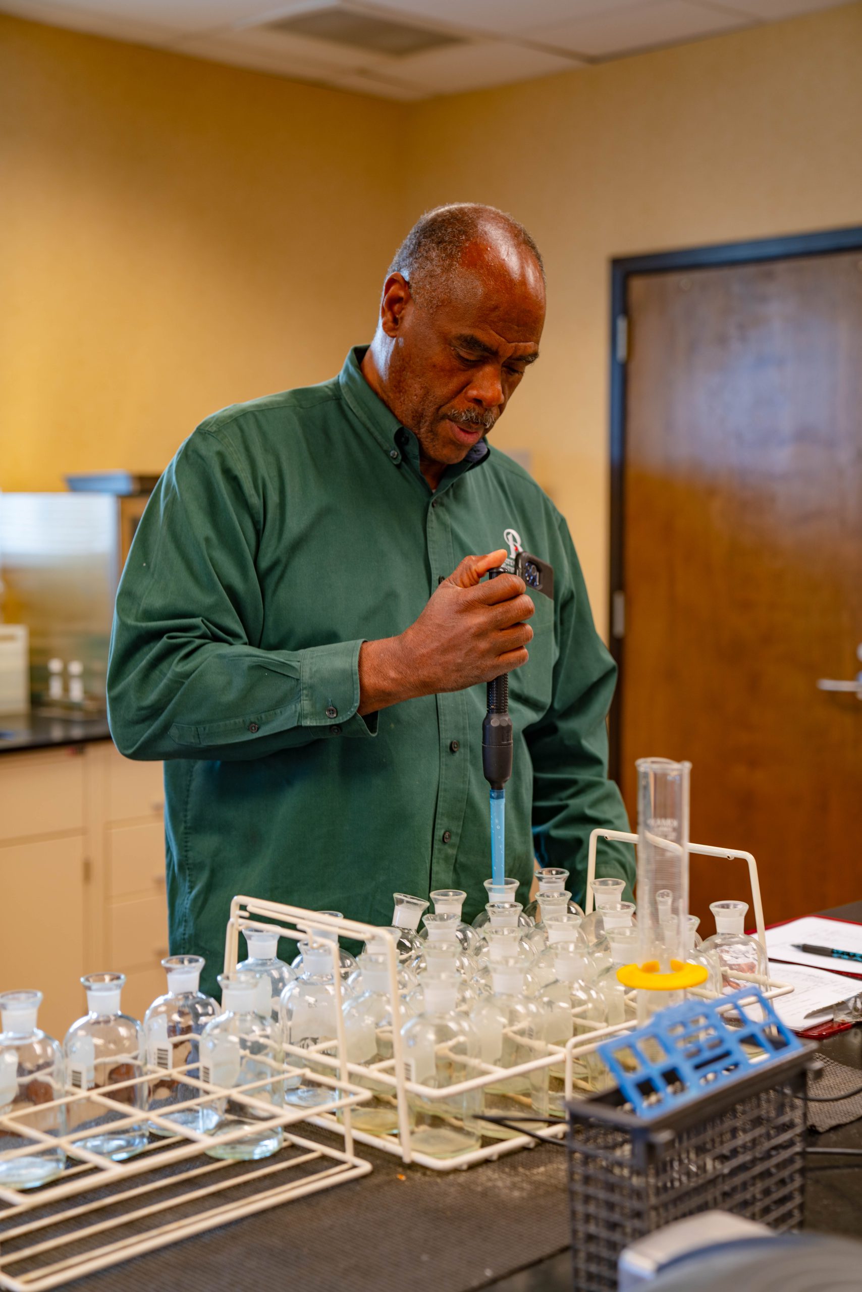 Wastewater worker testing water samples in the lab.