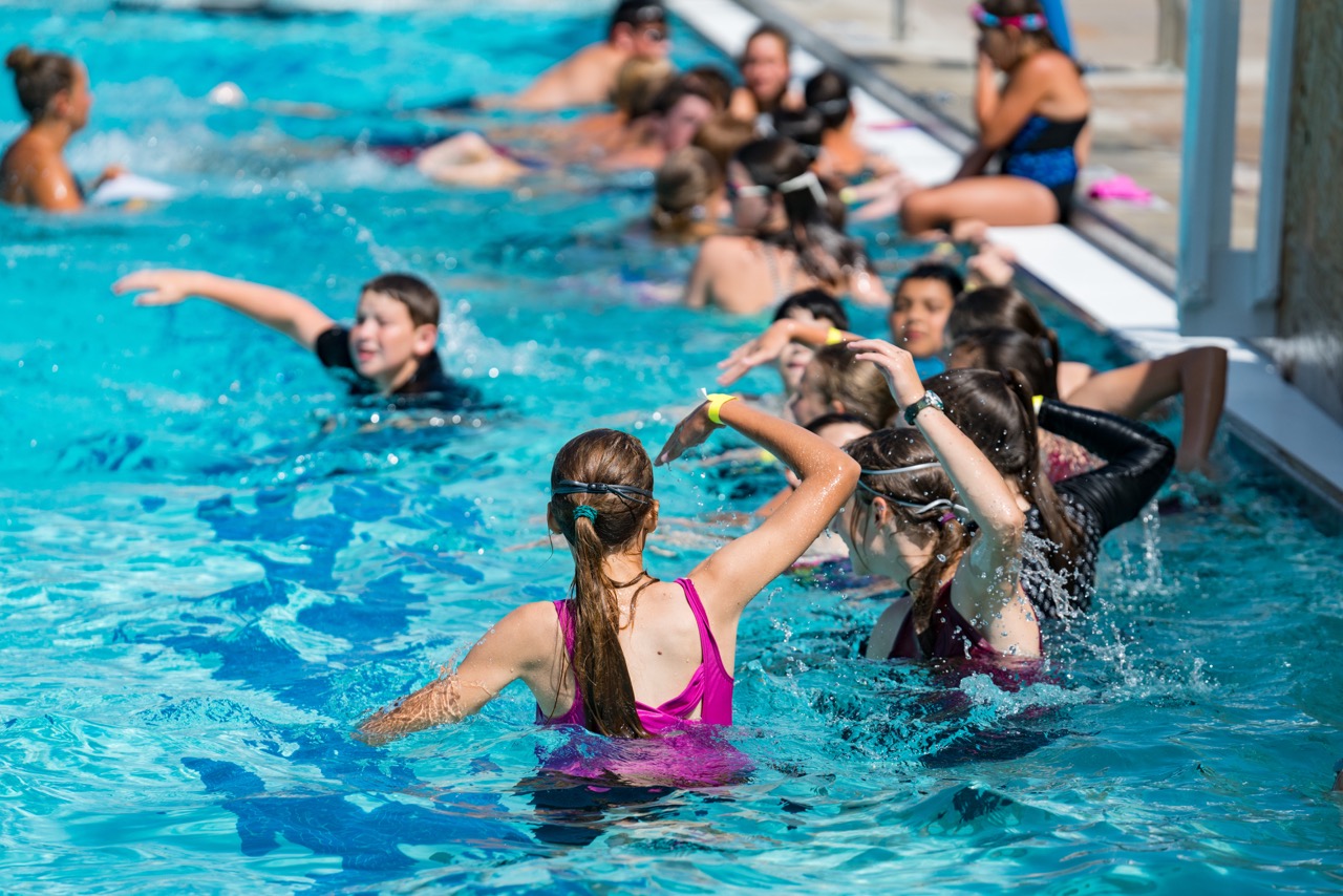 Kids learning how to swim at the Bryan Aquatic Center for the World's Largest Swim Lesson event.