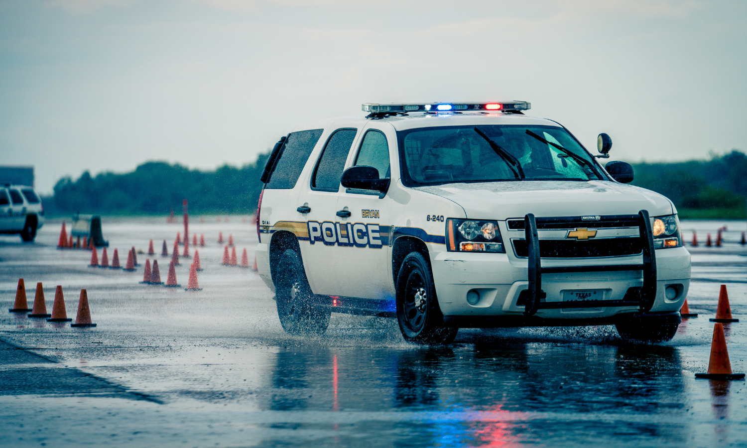 Police car driving in rain