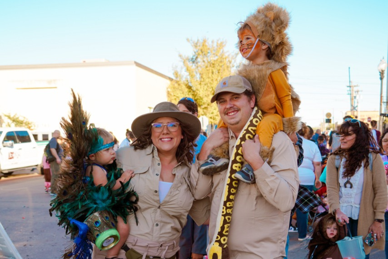 Photo of a family dressed up as zoo keepers with animals. 