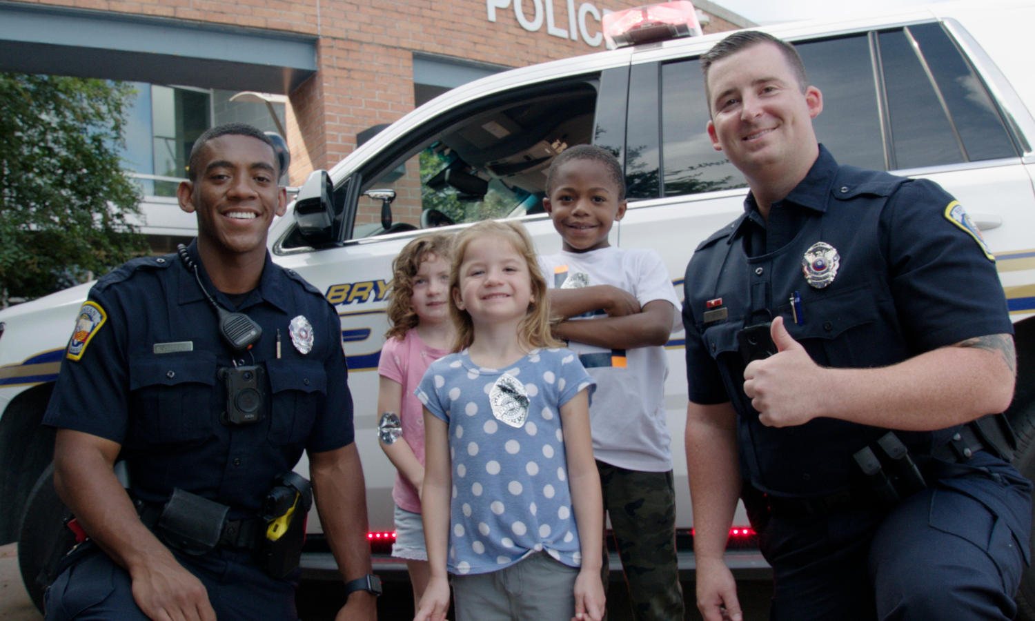 Photo of Bryan Police Officers with children at an event.