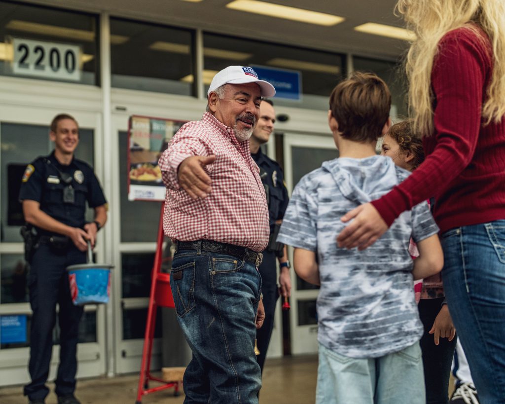 Photo of Mayor Bobby Gutierrez welcoming children donating to the Salvation Army at the Mayor's Ring Off in 2022.