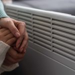 warming hands by a heater