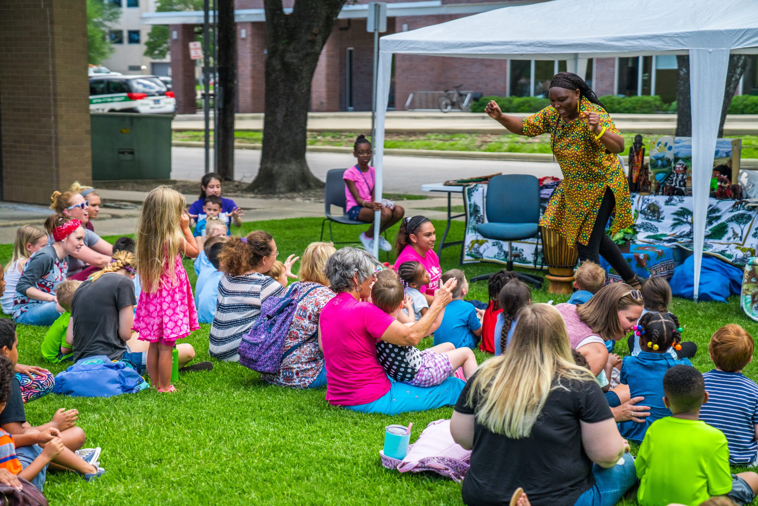 Photo of an African storyteller on the lawn of Mounce Library. 