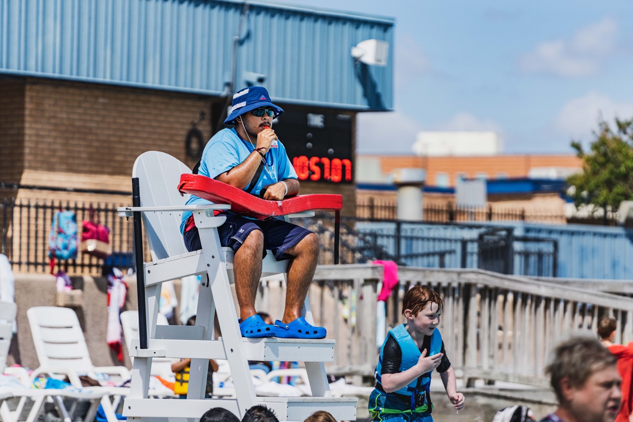 Lifeguard scanning pool from lifeguard stand. 