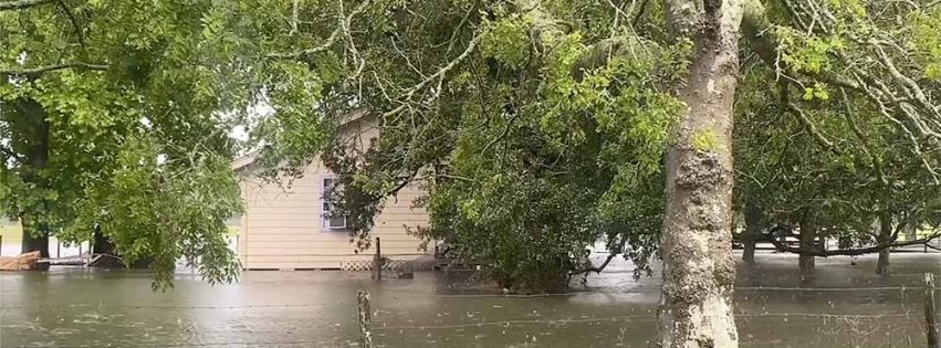 Flooding waters around a house and yard.