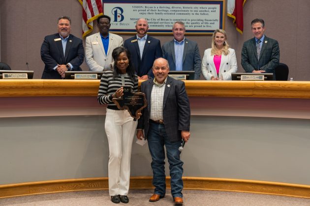 Bea Saba receiving an award at City Council Meeting.