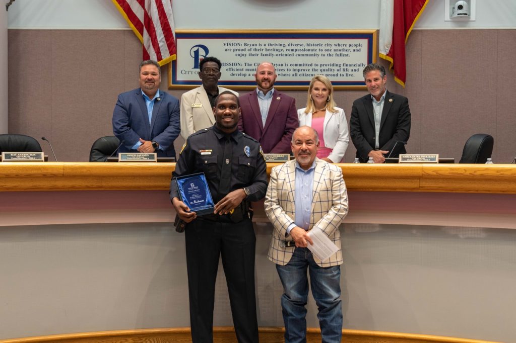 Photo of Bryan City Council with Bryan Police Officer Najee Watson 