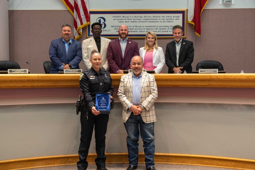 Photo of Bryan City Council with Bryan Police Officer Sarah Popham