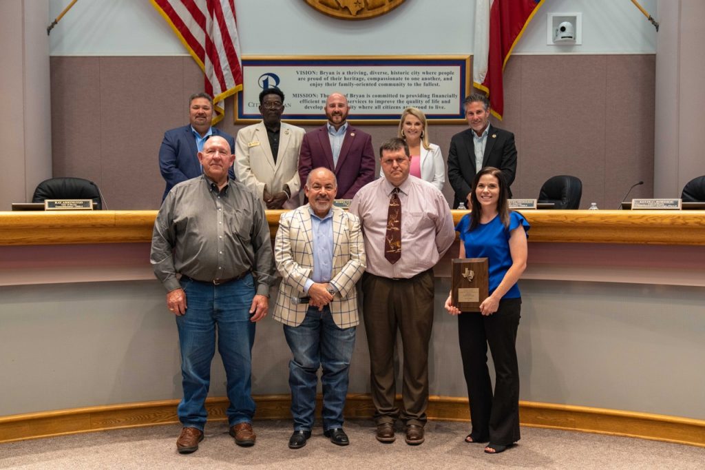 Photo of Bryan City Council with city staff and a representative from the Brazos Valley Groundwater Conservation District.  