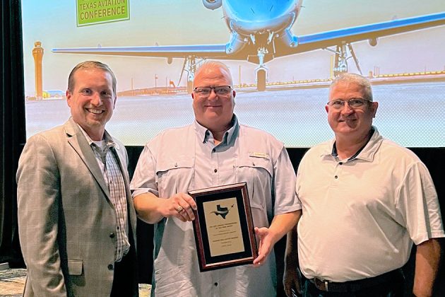 Brandon Reid receiving the 2025 Airport Professional of the Year award at the Texas Aviation Conference, standing between Kevin Russell and Joseph Dunn