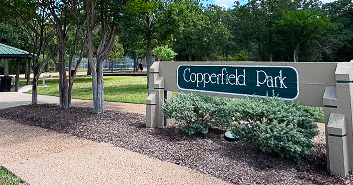 Copperfield Park sign with park in the background