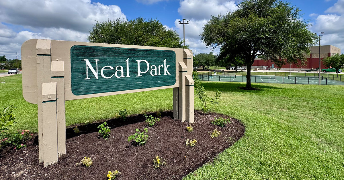 Neal Park sign with park in the background