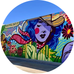 colorful mural with a woman's face on the side of a building