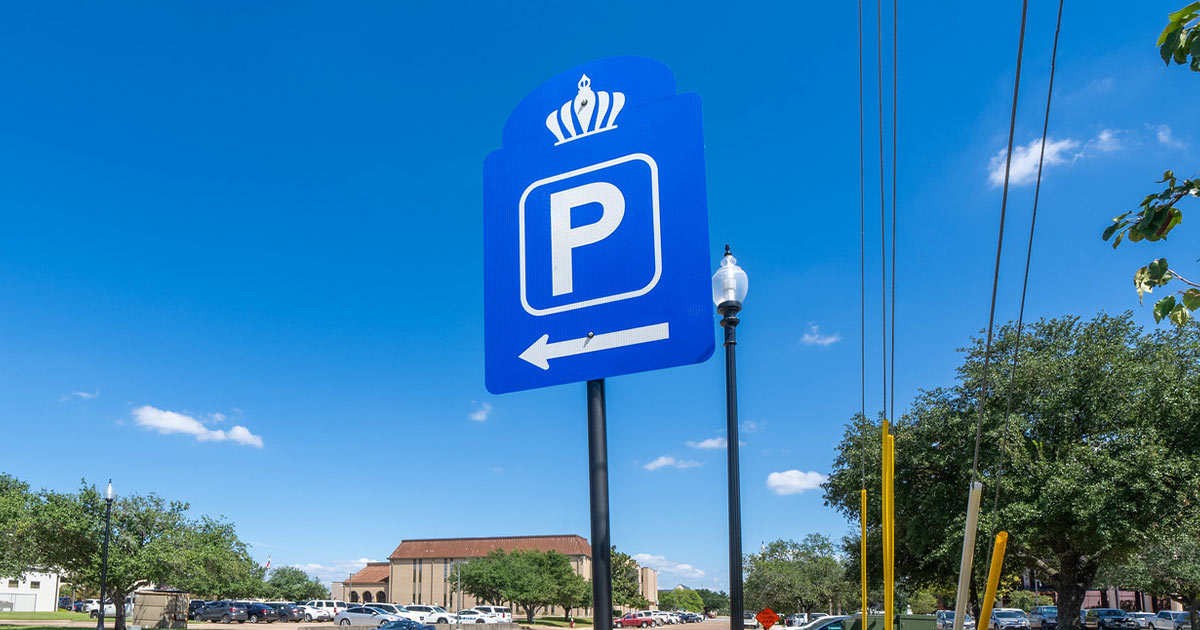blue parking sign with downtown Bryan in the background